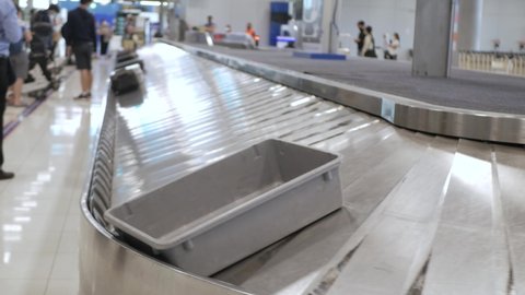 View of airport luggage conveyor belt. empty baggage claim belt with pastic tray on it.