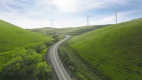 Cinematic solar power plant and Windmills aerial view on sunny summer day. Renewable energy, Green technology, climate change efforts concept footage. People on bicycles riding by countryside road USA - Powered by Shutterstock - Get 15% off with code: PIKWIZARD15