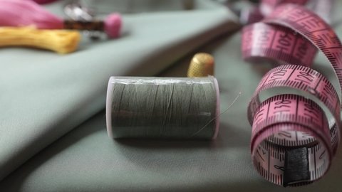 Close up shot of thimble and thread.  Tailor craft equipment  