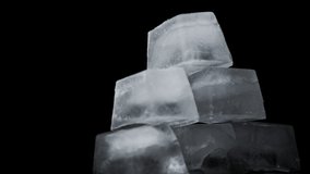 Square ice cubes are spinning on a black background. Water freezing in square shape. Wet ice rotates around its axis. - Powered by Shutterstock - Get 15% off with code: PIKWIZARD15