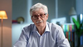 Portrait of smiling aged man looking at camera and talking having video conference. Senior male teacher have webinar online - Powered by Shutterstock - Get 15% off with code: PIKWIZARD15