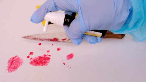 evidence idfresh splatter of red blood on white table, sharp knife stained at crime scene, entification markers, forensic specialist identifies fingerprints at crime scene with chemicals