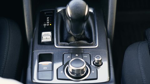 Driver hand shifting the gear stick. Top view close up. Transportation and vehicle concept.