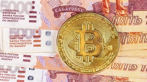 Bitcoin coins new virtual money on Russian banknotes A close up image of bitcoins with Russian rubles banknotes Bitcoin coin on the background of Russian rubles Bitcoin Russia Ruble Cryptocurrency