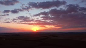 Magic sunset over agrarian lands in summer. Stunning footage from a bird's eye view. Location place agrarian region of Ukraine, Europe. Cinematic drone shot. Filmed in UHD 4k video. Beauty of earth.