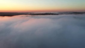 A thick fog covered the valley early in the morning. Footage from a bird's eye view. Location place Dniester canyon, Ukraine, Europe. Cinematic drone shot. Filmed in UHD 4k video. Beauty of earth.