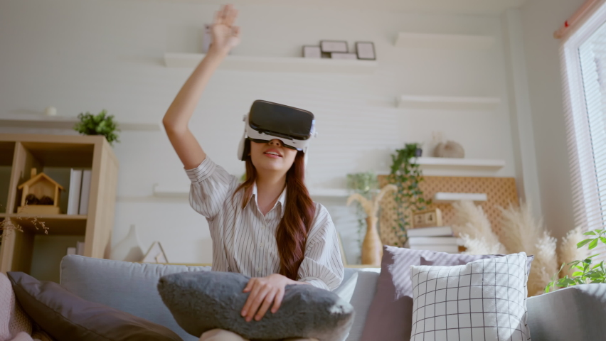 happiness exited asian female teen hand wave along with her virtual concert performance via virtual goggle virtual interactive headset,asia woman stay home innovation technology lifestyle vr at home - Powered by Shutterstock - Get 15% off with code: PIKWIZARD15