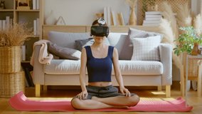 Peaceful clam asian female woman wearing virtual reality glasses meditating at home in breath train hands in namaste enjoying simulation and relax. Virtual  technology experience in metaverse world - Powered by Shutterstock - Get 15% off with code: PIKWIZARD15
