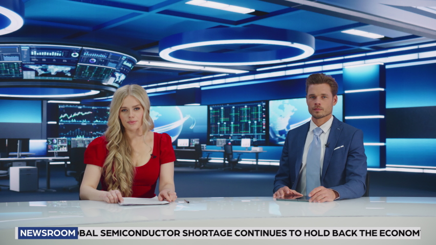 TV Live News Program: Two Presenters Reporting, Talking, Discussing Daily Events. Television Cable Channel Team of Male and Female Anchors Talks Politics, Science. Playback Newsroom Studio. Wide