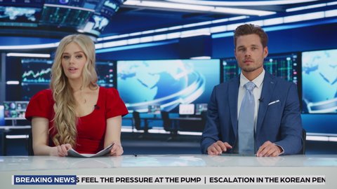 TV Live News Program: Two Presenters Reporting, Talking, Discussing Daily Events. Television Cable Channel Team of Male and Female Anchors Talks Politics, Science. Playback Newsroom Studio. Wide