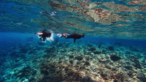 Couple snorkeling in the tropical sea in Maldives