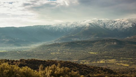 Panning time-lapse of the Regino valley in the Balagne region of Corsica with the snow capped mountains of Monte Padru, Monte San Parteo and Monte Grosso in the distance