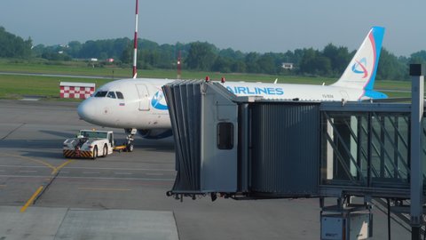 KALININGRAD, RUSSIA - JULY 28, 2021: Passenger plane Airbus A321 Ural Airlines being towed to the runway at Khraborovo Airport, Kaliningrad (KGD).