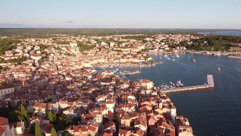 Rovinj at Istria, Croatia - Aerial Drone View (Reveal) of the Peninsula with Church Tower, Boulevard, Colorfol Houses and Port at the Adriatic Sea