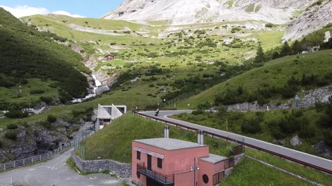 Stelvio Mountain Pass at South Tyrol, Italy - Aerial Drone View of a MotorCycle driving the Famous Road with Curves and Hairpins - Giro d' Italia Cycling Lap