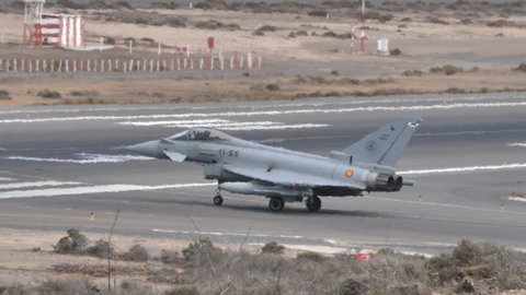 Gran Canaria Spain OCTOBER, 21, 2021 Grey camouflage fighter jet of NATO taxiing no the airport runway to take off. Eurofighter Typhoon of Spanish Air Force supersonic combat aircraft