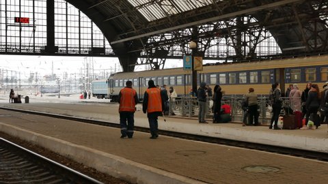 LVIV, UKRAINE - JANUARY 5, 2018: Two railway workers in uniform on the platform of Lviv train station, Ukraine. 4K, Editorial, Pan