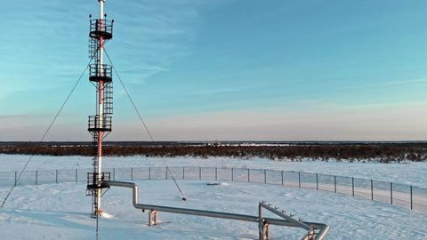 A drone flies around a pipe to relieve emergency gas pressure on the pipeline of an oil and gas refinery in Russia in winter. Fuel crisis, rising prices for gas and gasoline in Europe and the USA.