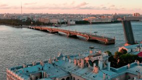 The aerial video of the divorced Trinity Bridge over the Neva River, annual celebration of traditional holiday of student Scarlet Sails at sunset in Russia, St.Petersburg