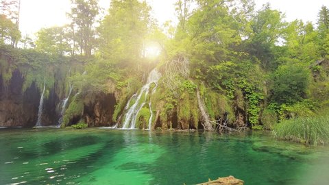 sunshine on underwater trees of the Galovacki Buk waterfall of Plitvice National Park in Croatia. Milino Jezero lake and forest in Lika region. UNESCO World Heritage of Croatia named Plitvicka Jezera