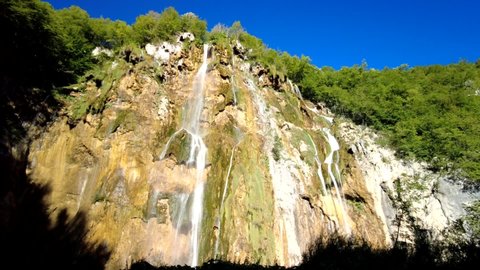 Timelapse: bottom view with rainbow on the Veliki slap Great Waterfall of Plitvice Lakes National Park in Croatia in the Lika region. UNESCO World Heritage of Croatia named Plitvicka Jezera.