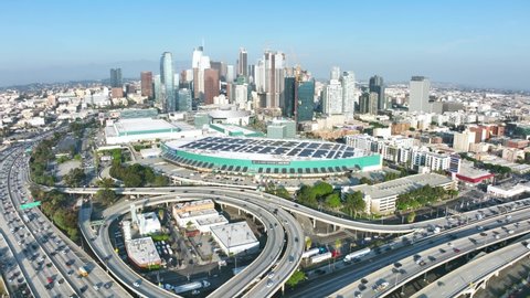 LOS ANGELES, CA, USA - March 15, 2022: Drone 4k. Aerial view of downtown Los Angeles. Cars on intersection of highway roads. Modern business offices, apartments. American urban life.
