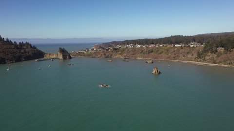Wide shot of Trinidad Bay and town, aerial forward.