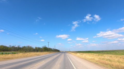 POV driving through rural Rio Grande Valley in southern Texas past vegetable fields ; concepts of agriculture, food and open road