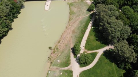 Tilt up aerial shot over Isar river in Munich revealing the German Museum