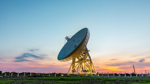 Astronomical radio telescope and beautiful sky clouds at sunset. 4K time lapse footage.