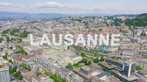 Inscription on video. Lausanne, Switzerland. Flight over the central part of the city. Glitch effect text, Aerial View, Departure of the camera