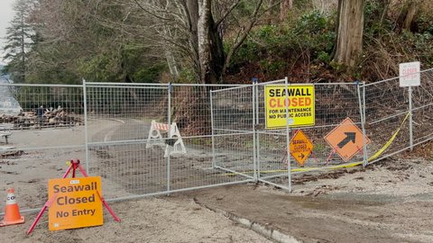 Vancouver Stanley Park seawall heavily damaged by multiple windstorms and king tide in the area. Seawall closed sign on Third Beach