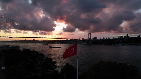 Turkish Flag and 15th July Martyrs Bridge in the Sunset Drone Video, Beylerbeyi Beach,  Uskudar Istanbul, Turkey