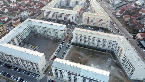 Residential block of high rise apartment buildings made of concrete in a big city in Europe - triangle shaped flat complex in urban environment. Aerial drone view of Podgorica Montenegro, Mar 25.2022