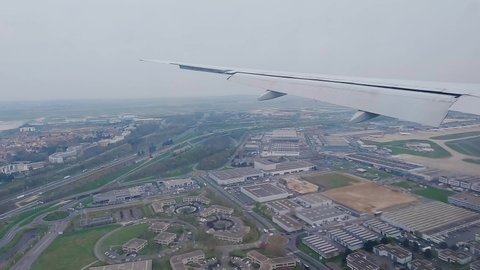 Window view of an airplane landing. Flying on a plane, landscape from window during landing. 