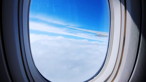 View from plane window. Plane window view during flight. Airplane wing. Looking through plane window. Travel concept. Sky From The Plane Window. 