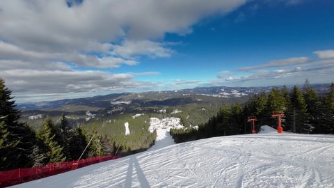 Skiing. Action camera of skier going downhill on alpine ski on snow slopes in the mountains. Man going downhill on ski having fun on slopes. Winter sport outdoor activity video