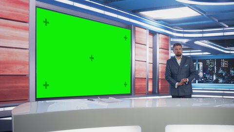 Newsroom TV Studio Live News Program: Caucasian Male Presenter Reporting News, Uses Big Green Screen Chroma Key Screen. Television Cable Channel Anchor Talks. Network Broadcast Mock-up Playback