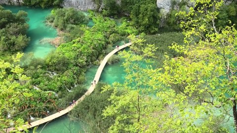 Croatia, Europe - August 2021: lookout over the bridge on Korana river with people. Plitvice Lakes National Park of Croatia in Lika region. UNESCO World Heritage of Croatia named Plitvicka Jezera.