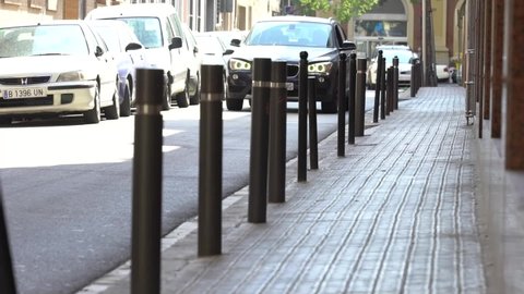 Barcelona, ​​Spain - April 23, 2019: stainless steel bollards at concrete pavement.
