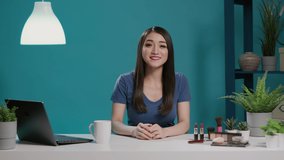 Asian woman filming makeup tutorial for online channel, recording beauty cosmetics video on vlogging camera for social media. Young blogger using product to give glam tips. Tripod shot.