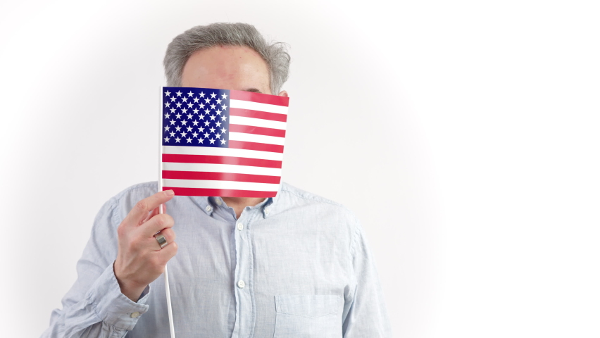 40s caucasian man hiding behing the US flag - portrait isolated on white background. High quality photo