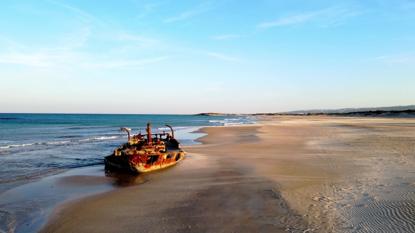 Taken at Habonim beach, israel. Wrecked boat, on the shoreline , on the beach at sunset in Moshav Habonim.