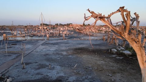 Horrifying aftermath of villa Epecuen, after the village resurfacing from the catastrophic flood event that destroyed the popular tourist town, slow aerial pull out shot of the ruins.