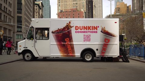 New York NY USA-April 4, 2022 Visitors to Flatiron Plaza in New York visit the Dunkin’ Connections brand activation to sample their iced coffee.