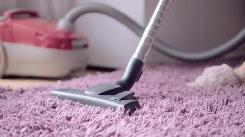 Housewife Using Vacuum Cleaner While Cleaning Floor. Vacuum Cleaner Cleaning Home Apartment. Housekeeping Routine. Domestic Hoover Appliance Cleaner. Maid Clean Dust On Carpet In Living Room Housework
