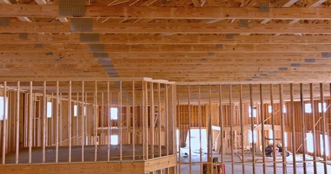 Beams roof trusses frame an interior view of a framed building construction of new wooden house