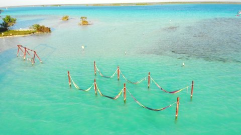 Cenote Cocalitos. Swings and Hammocks in turquoise water of seven colores lagoon near Bacalar, Quintana Roo, Mexico