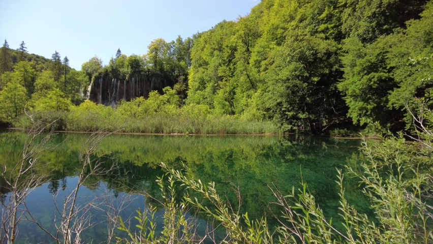 Veliki Prstavac waterfall reflected in the Potok Plitvice lake of Plitvice National Park in Croatia. UNESCO World Heritage of Croatia named Plitvicka Jezera.