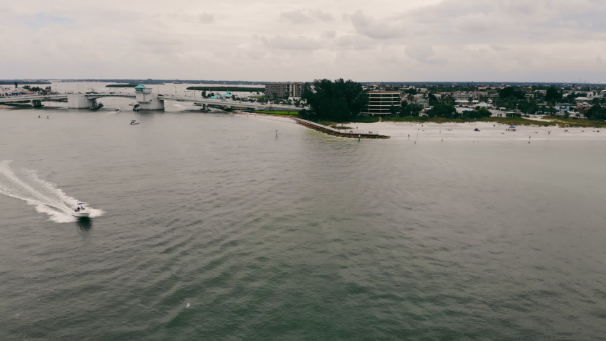 Top view of a speedboat leaving the city of St. Petersburg Florida near the coastline on a cloudy day. Transportation of a motor boat in the sea.